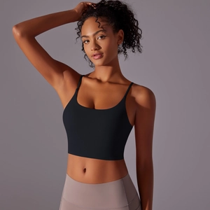 Detail view of high-impact black sports bra with thin straps and elastic fabric fit