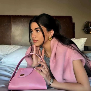 Minimalist geometric pink leather handbag styled with elegant 18k gold plated earrings