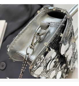 Close-up of sparkling silver sequins and premium metal chain hardware on the crossbody bag