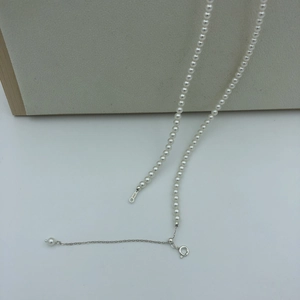 Detailed view of white pearl necklace with S925 sterling silver lobster clasp and extension