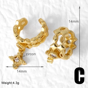 Detail showing 14mm gold-plated C-shaped ear cuff with zircon star pendant and specs