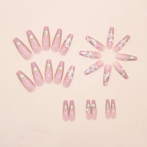 Detailed view of handmade press-on nails with white flowers, pearls, and gold edges