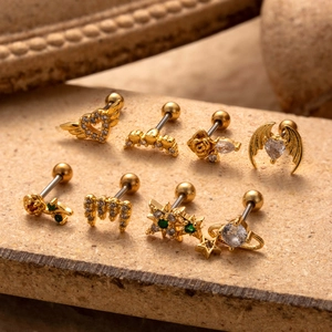 Set of 8 gold stainless steel stud earrings with heart, crown, and green crystal designs