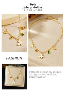 Detail of gold chain necklace with butterfly, star, and geometric enamel charms