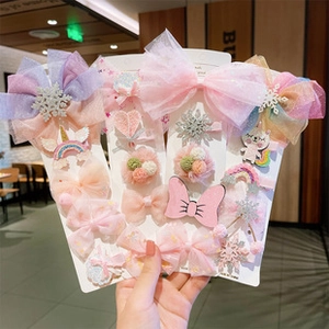 Set of pink and purple children's hair accessories with bows, snowflakes and unicorns