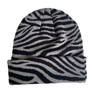Detail of grey zebra pattern on knit beanie featuring premium woven fabric texture