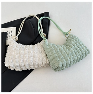 Detail of bubble textured pleats on minimalist off-white and green cloud shoulder bags