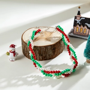 Braided Christmas faux pearl necklace in festive red, green, and white beads