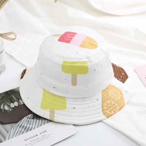 Detail of white cotton bucket hat featuring colorful popsicle and ice cream patterns
