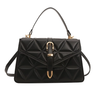 Minimalist black quilted handbag with gold hardware and detachable crossbody strap