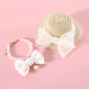 Detailed macro view of pet straw hat with lace bow and white pearl bow collar set