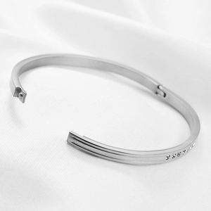 Macro shot of silver stainless steel cuff bracelet with sparkling zircon detailing