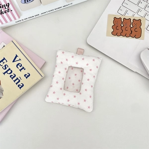 Detail of soft padded white card holder with pink stars and transparent window