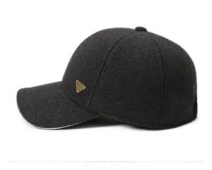 Detail view of charcoal gray wool baseball cap featuring a golden triangular SPIRIT logo