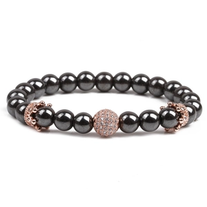 Detailed shot of black natural stone beads bracelet with rose gold pavé crystal charm