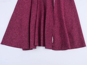 Detail of burgundy tweed skirt hem showing mixed heather texture and wavy draped edges