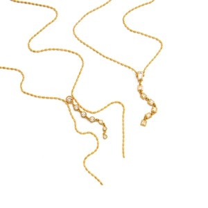 Y-shaped 18K gold stainless steel necklace with crystal tassels on a plain background