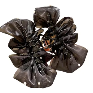 Elegant oversized black tulle flower hair claw with white pearls and mesh bow layers