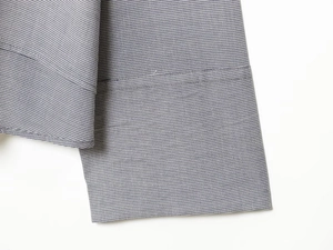 Detail of checkered shirt cuff in grey and blue cotton fabric with sharp texture