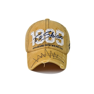 Detail of vintage 1985 embroidery and distressed brim on washed cotton baseball cap