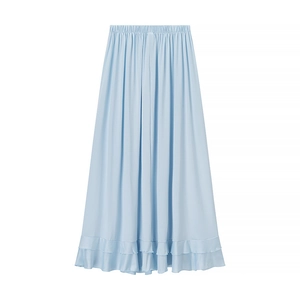 Detail of light blue bohemian maxi skirt featuring elastic waist and ruffled hemline