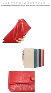Close-up of pebble grain leather long wallet with wristlet strap and tassel detail