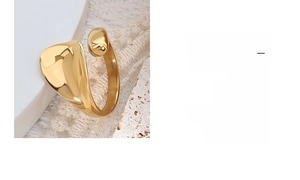 Detailed view of an irregular 18k gold geometric ring with polished finish