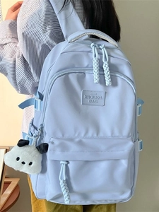 Light blue minimalist high-capacity nylon backpack with multi-pockets and plush dog charm