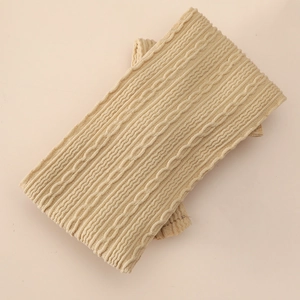 Detailed macro view of beige cable knit pattern on soft baby headband material