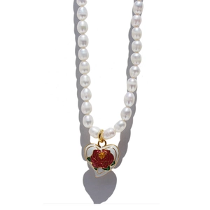 Vintage pearl necklace with oil painting enamel rose heart pendant on a white background