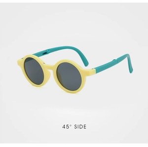 Detail view of foldable kids round sunglasses in yellow and green from a 45-degree angle
