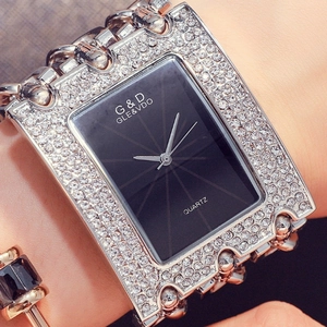 Close-up of sparkling rhinestone chain bracelet watch with a sleek black dial on wrist