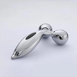 Detailed macro view of 3D roller spheres on the silver ergonomic face massager