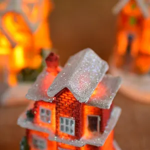 Christmas miniature resin house with snowy roof and glowing LED lights for holiday decor
