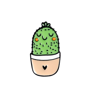 Close-up of cute cartoon cactus enamel pin with pink heart pot and green finish