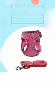 Close-up of pink breathable mesh dog harness with reflective strips and leash set