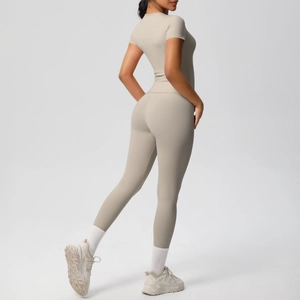 Detail view of beige two-piece fitness set with high-waist leggings and slim-fit top