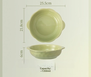 Detail view of 10-inch cream green ceramic soup bowl with scalloped edges and dual handles