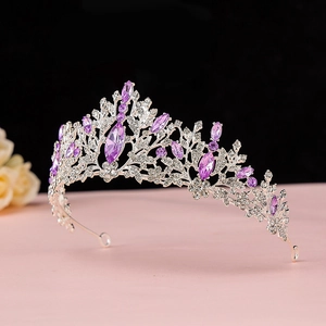 Detailed macro view of baroque silver crown with purple crystals and sparkling rhinestones