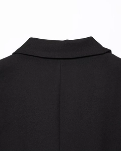 Detail shot of the rear collar and weave texture on this minimalist black blazer jacket