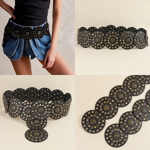 Detail of black wide leather belt featuring metallic studs and circular ring link design