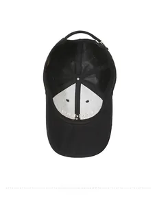 Internal detail of a black cotton baseball cap showing reinforced seams and stitching