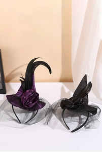 Detailed close-up of a witch hat headband with purple mesh, feathers, and decorative roses