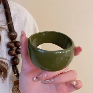 Polished olive green acrylic resin thick bangle bracelet in a minimalist retro style