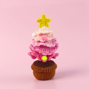 Detail of handmade crochet pink Christmas tree ornament with yellow star and brown pot