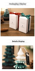 Detail of handmade Christmas tree candles in white and green with a premium gift box