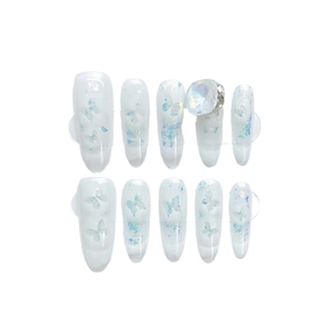 Long almond press-on nails with iridescent butterfly sequins and large central rhinestone
