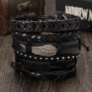 Multilayer black leather woven bracelet set featuring wing charm and rivet detailing
