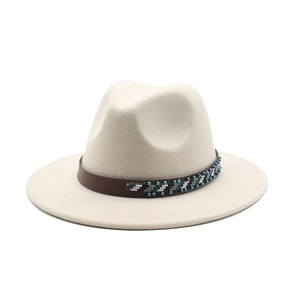 Detailed view of fedora hat with brown leather band and blue beaded decoration