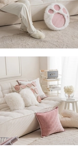 Detailed view of pink cat paw plush pillow with soft texture for modern sofa decor